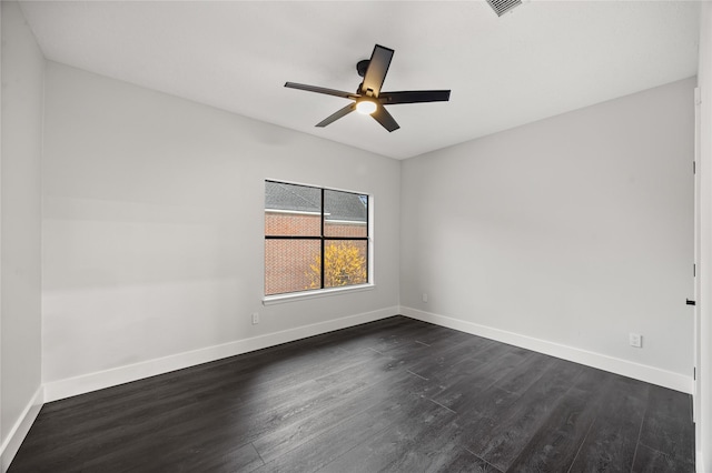 spare room featuring ceiling fan and dark wood-type flooring