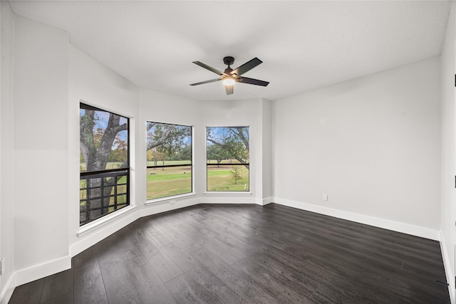 empty room with ceiling fan and dark hardwood / wood-style floors