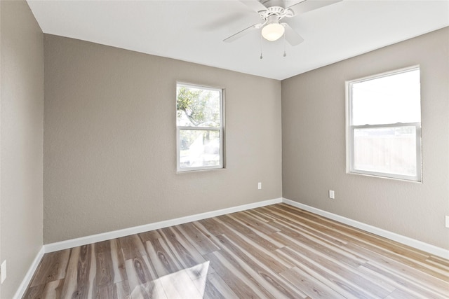 spare room featuring ceiling fan and light hardwood / wood-style flooring