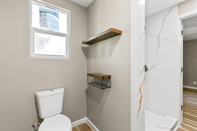 bathroom featuring hardwood / wood-style floors and toilet