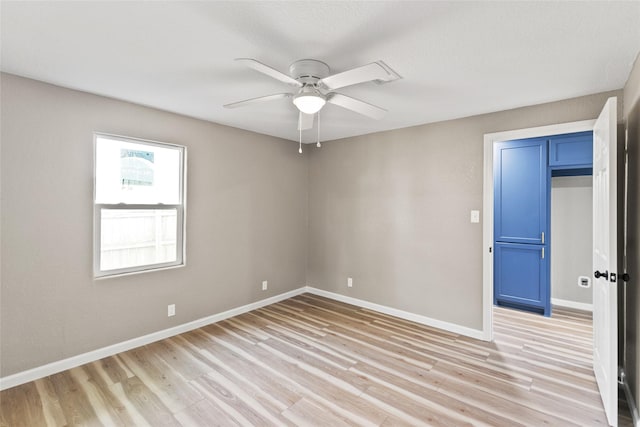 empty room with light hardwood / wood-style flooring and ceiling fan