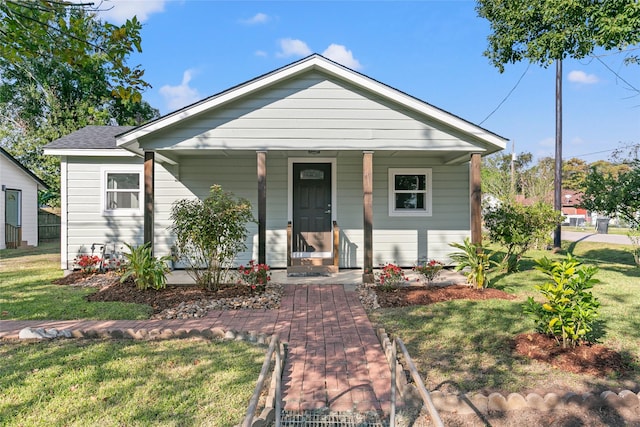 bungalow-style house with a front lawn