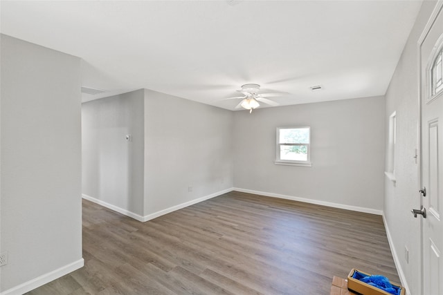 spare room featuring hardwood / wood-style floors and ceiling fan