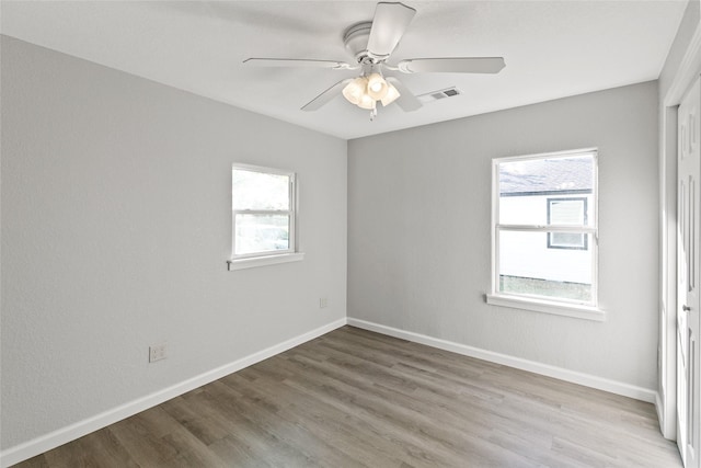 unfurnished room featuring ceiling fan, plenty of natural light, and light hardwood / wood-style floors