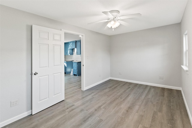 spare room with ceiling fan and light hardwood / wood-style flooring