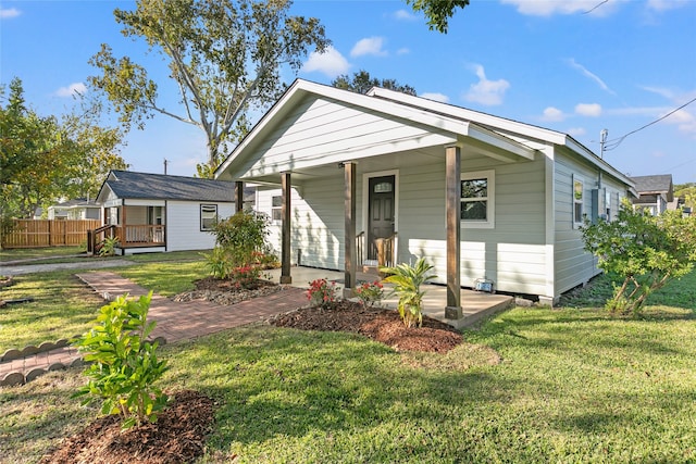 bungalow-style house with covered porch and a front yard