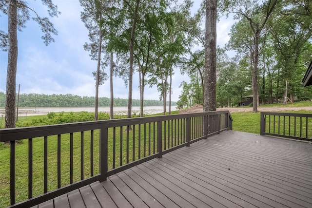 deck with a water view and a lawn