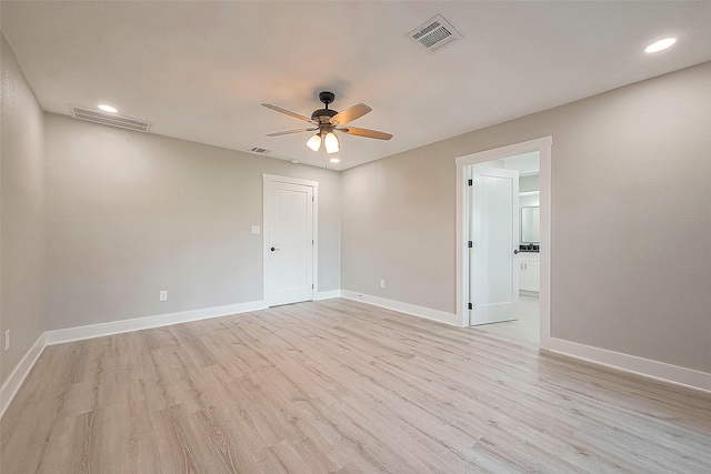 spare room featuring light hardwood / wood-style floors and ceiling fan