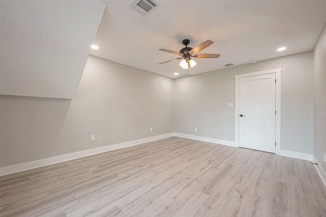 empty room with ceiling fan and light wood-type flooring