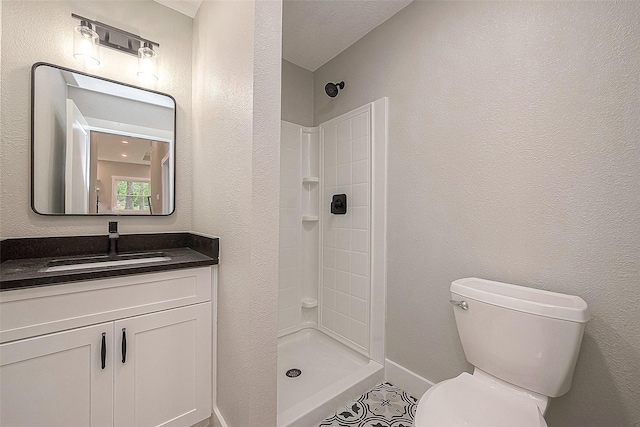 bathroom featuring vanity, toilet, and walk in shower