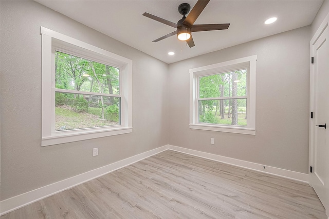 unfurnished room with ceiling fan, a healthy amount of sunlight, and light hardwood / wood-style floors