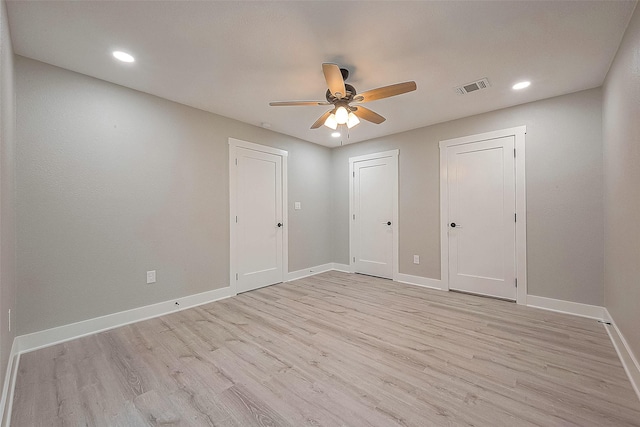 unfurnished bedroom with ceiling fan and light hardwood / wood-style floors