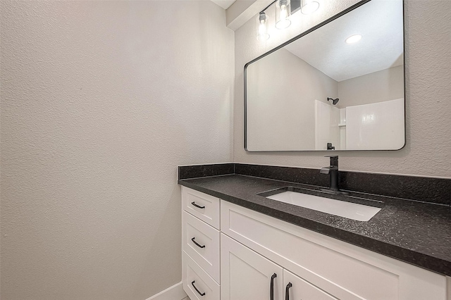 bathroom with vanity and walk in shower