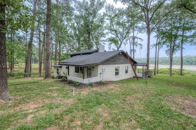 view of side of home with a lawn