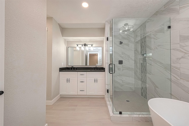 bathroom featuring vanity and independent shower and bath