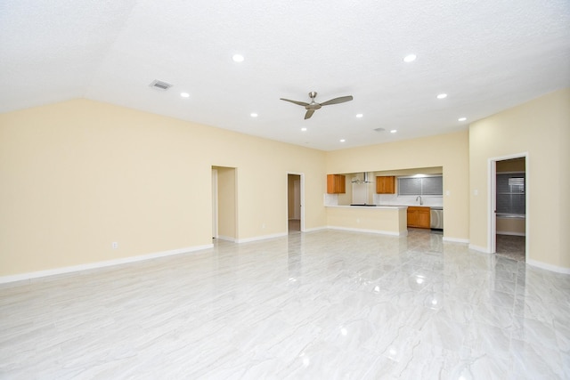 unfurnished living room featuring a textured ceiling, ceiling fan, and lofted ceiling