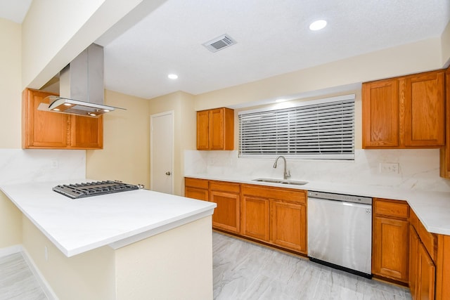 kitchen with backsplash, sink, island exhaust hood, and appliances with stainless steel finishes