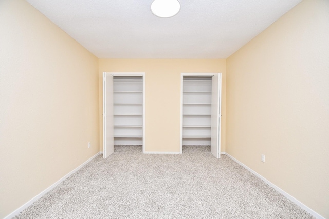 unfurnished bedroom featuring light carpet