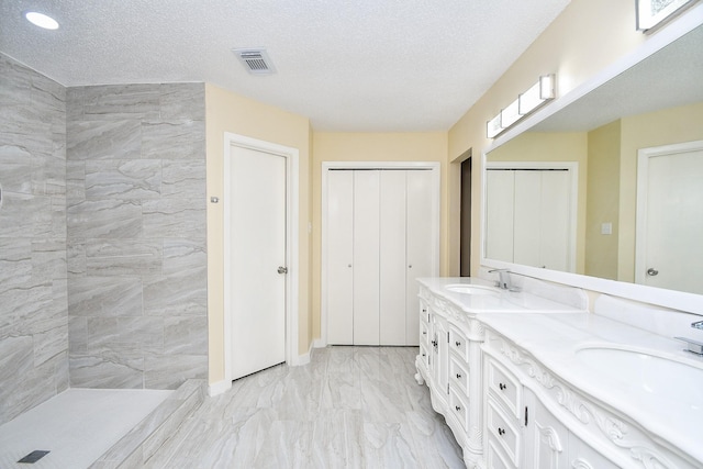 bathroom with a textured ceiling and vanity