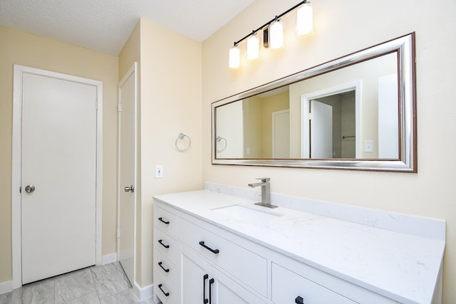 bathroom featuring vanity and a textured ceiling