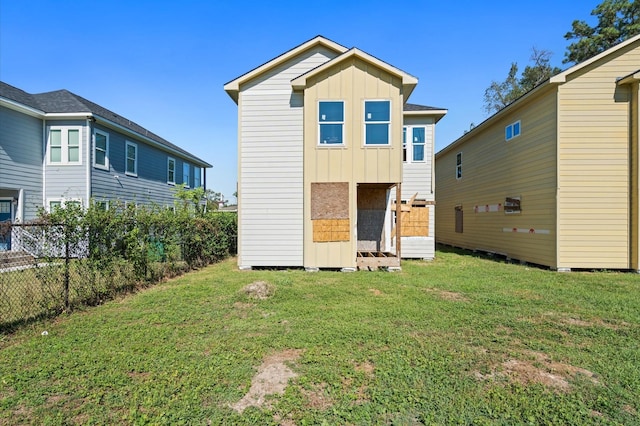 rear view of house featuring a yard