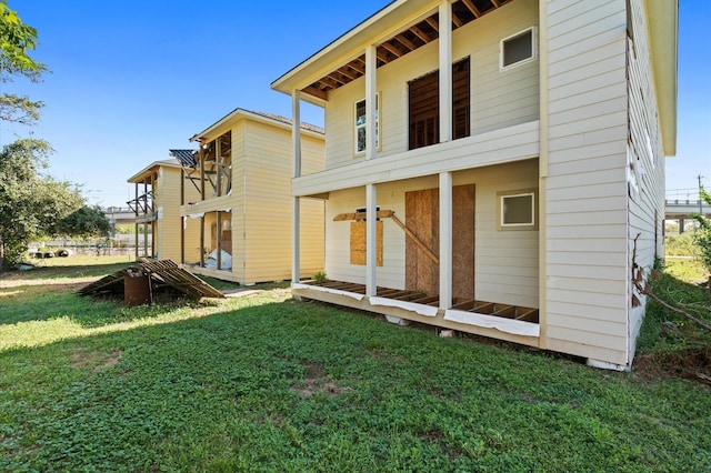 back of house with a lawn