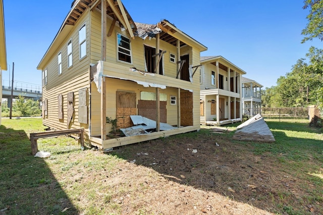 rear view of house featuring a yard