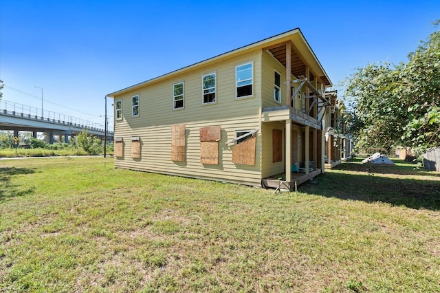 back of house with a lawn