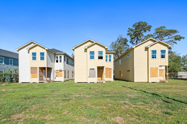 back of property featuring a yard and a storage shed