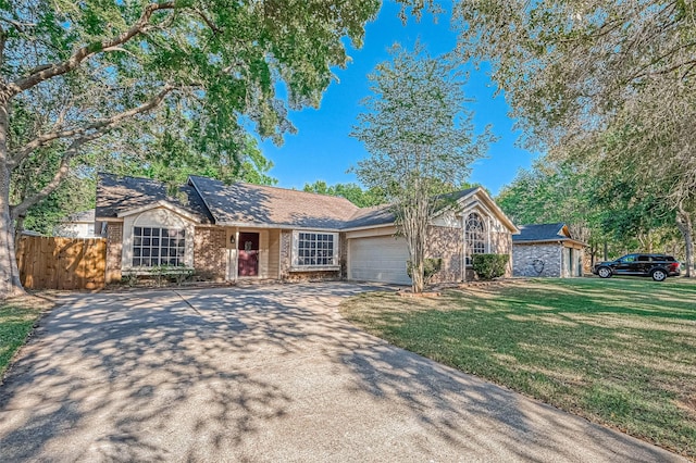 ranch-style home with a garage and a front yard