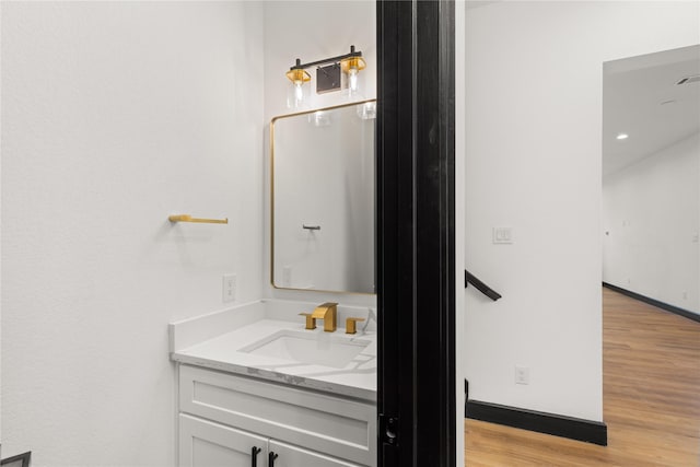 bathroom with hardwood / wood-style floors and vanity