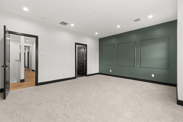 unfurnished bedroom with light colored carpet