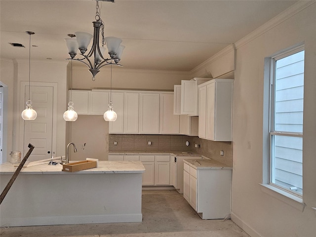 kitchen featuring sink, an inviting chandelier, decorative light fixtures, decorative backsplash, and white cabinets