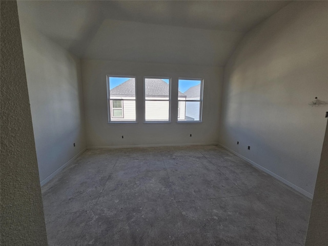 empty room with vaulted ceiling