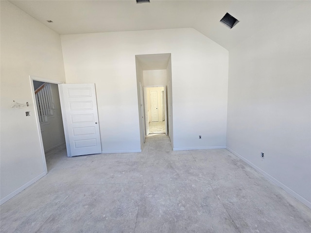 unfurnished bedroom featuring vaulted ceiling and a closet