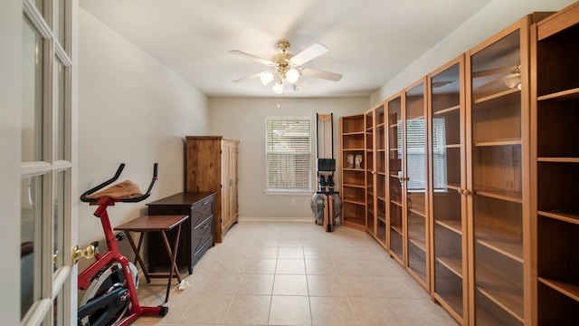 tiled home office featuring ceiling fan