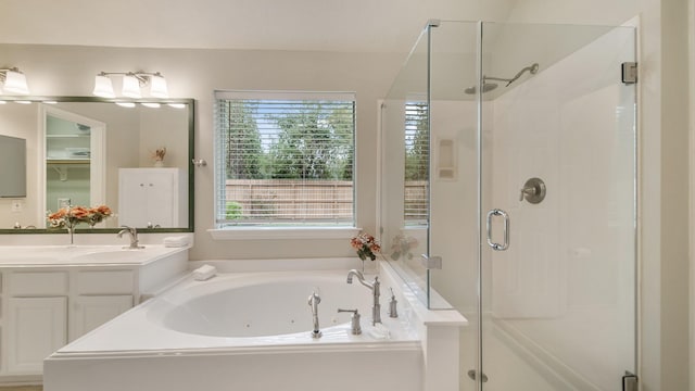 bathroom featuring separate shower and tub and vanity