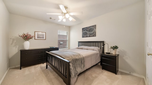 bedroom with ceiling fan and light colored carpet