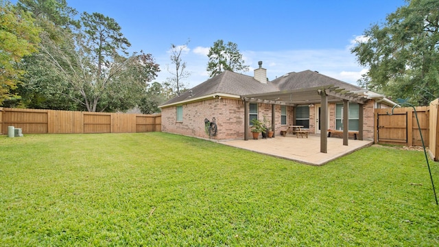 back of property with a yard and a pergola