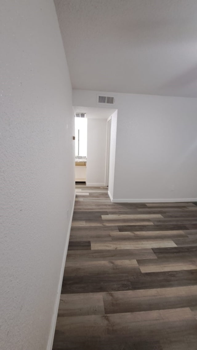 hallway with dark hardwood / wood-style floors