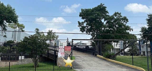 view of gate featuring a yard