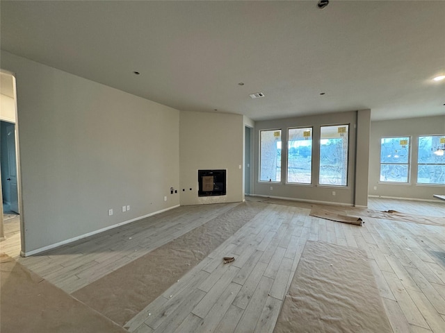 unfurnished living room featuring light wood-type flooring