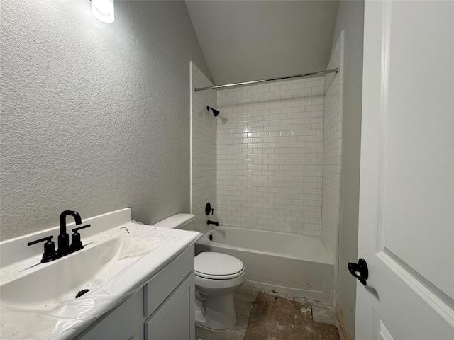 full bathroom with toilet, vanity, and tiled shower / bath