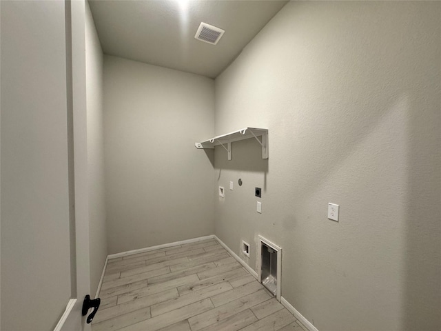 laundry area featuring hookup for a gas dryer, light wood-type flooring, washer hookup, and hookup for an electric dryer