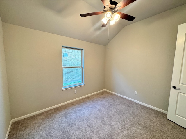 carpeted empty room with vaulted ceiling and ceiling fan