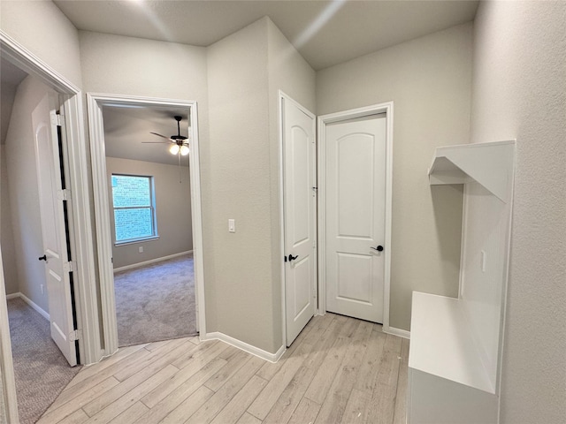 corridor with light hardwood / wood-style floors