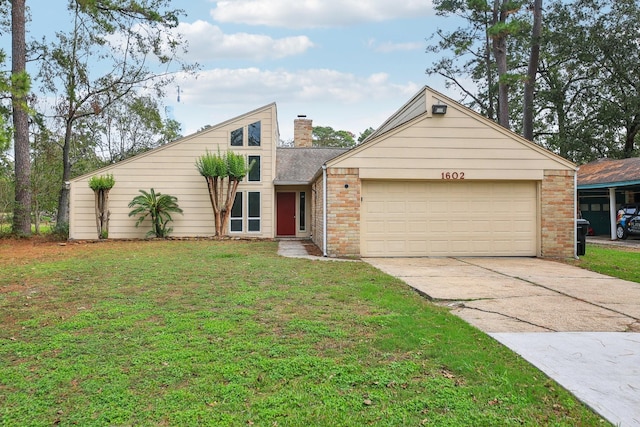 view of front of home with a front yard and a garage