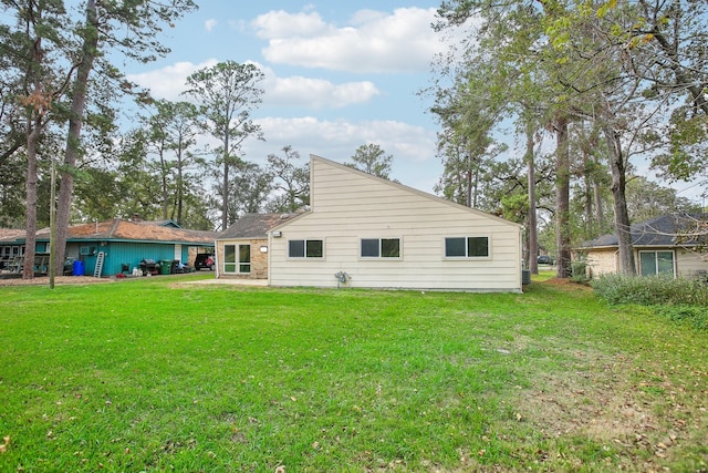 back of house with a lawn