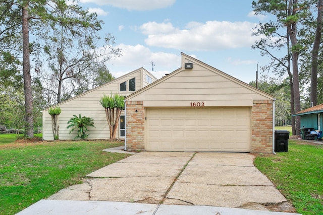 view of front of house featuring a garage and a front lawn