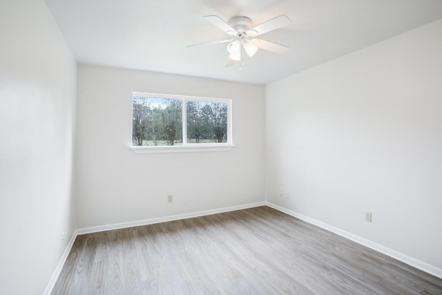 empty room featuring ceiling fan and light hardwood / wood-style flooring